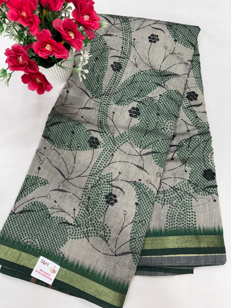Grey green tie-dye with black thread embroidery saree close-up